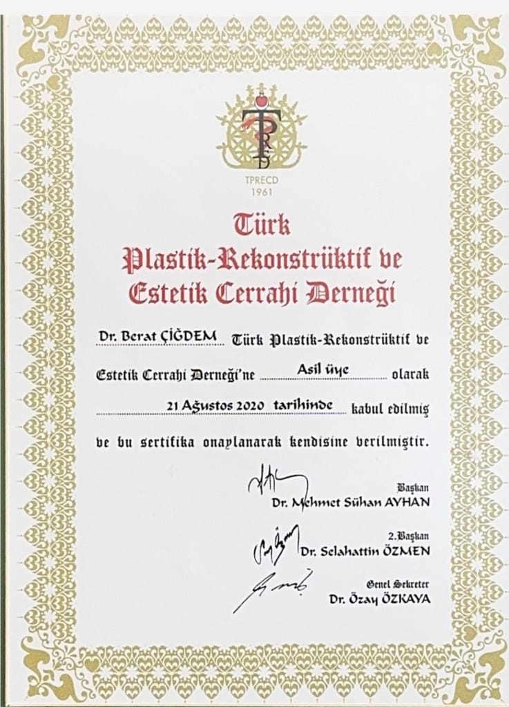 The provided image is a high-resolution, digital scan of an official membership certificate issued by the Turkish Society of Plastic, Reconstructive and Aesthetic Surgeons (TPRECD). The certificate features a formal, classic document design with a decorative, intricate gold-patterned border set against a cream-colored, textured parchment background. Centered at the top is the TPRECD organization logo, accompanied by the establishment year '1961'. The typography utilizes a sophisticated, black serif typeface for the main text, detailing that Dr. Berat Çiğdem was accepted as a full member on August 21, 2020. The document includes three distinct ink signatures from the President, Vice President, and Secretary General of the association, arranged in a traditional layout. The overall aesthetic is professional, authoritative, and archival in nature, capturing the prestige of medical institutional certification with sharp, clear contrast and clean lines.